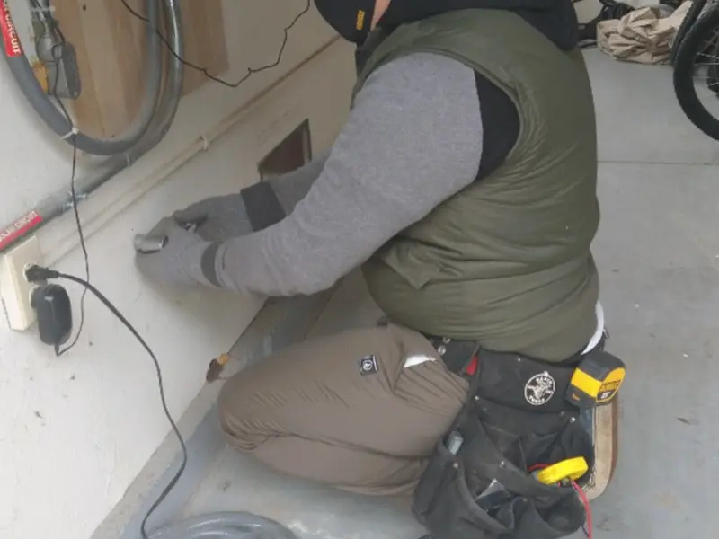 Electrician performing outlet wiring in a Pinetop-Lakeside garage